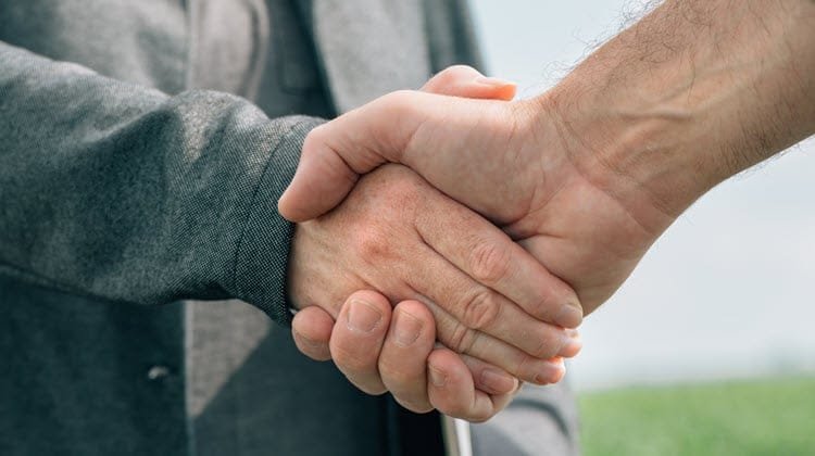 Minister and theologian shaking hands